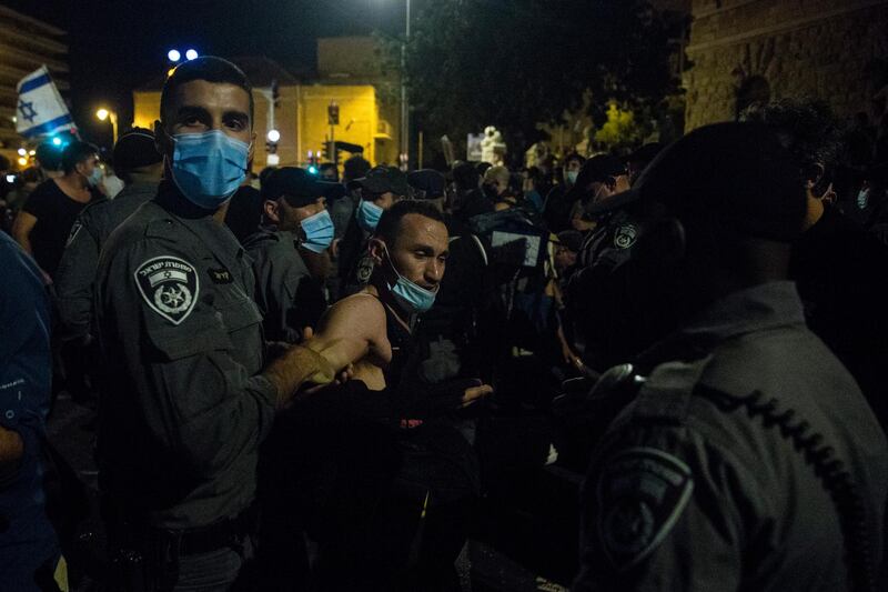 Police officers detain a protester during a demonstration in Jerusalem, Israel. Getty Images