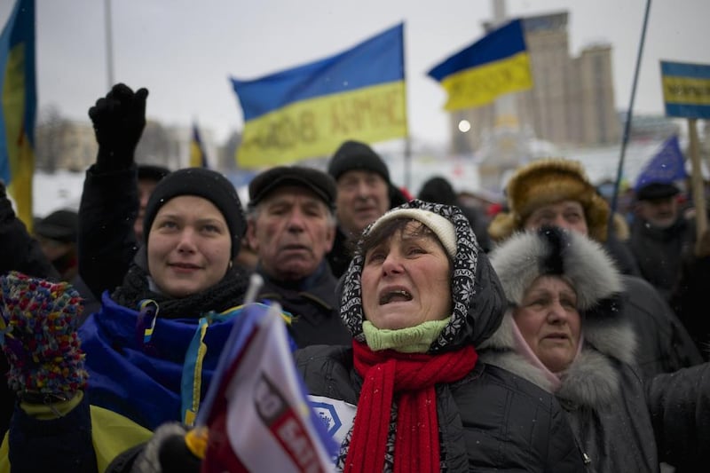 Some of the thousands of protesters who want Ukraine to align itself with the European Union and not Russia, as the country’s president proposes, make sure their views are heard at a rally in Kiev. Alexander Zemlianichenko / AP Photo