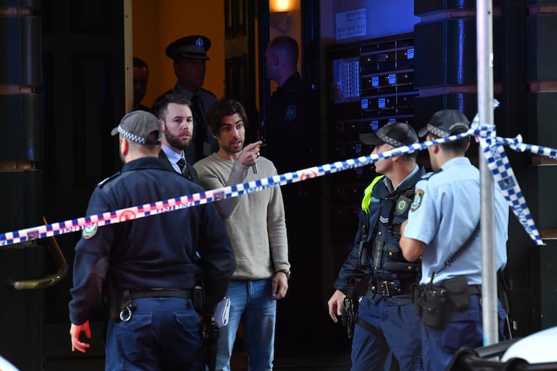Police speak with a witness (C) outside of an apartment building on Clarence Street during a police operation in Sydney, Australia.  EPA