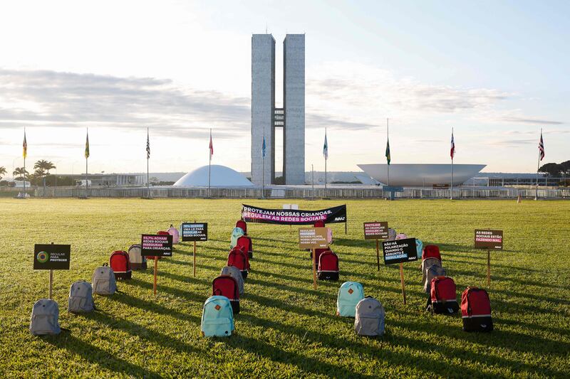 Backpacks representing victims of school shootings allegedly caused by the lack of regulation of social media stand in front of the National Congress in Brasilia, Brazil. AFP