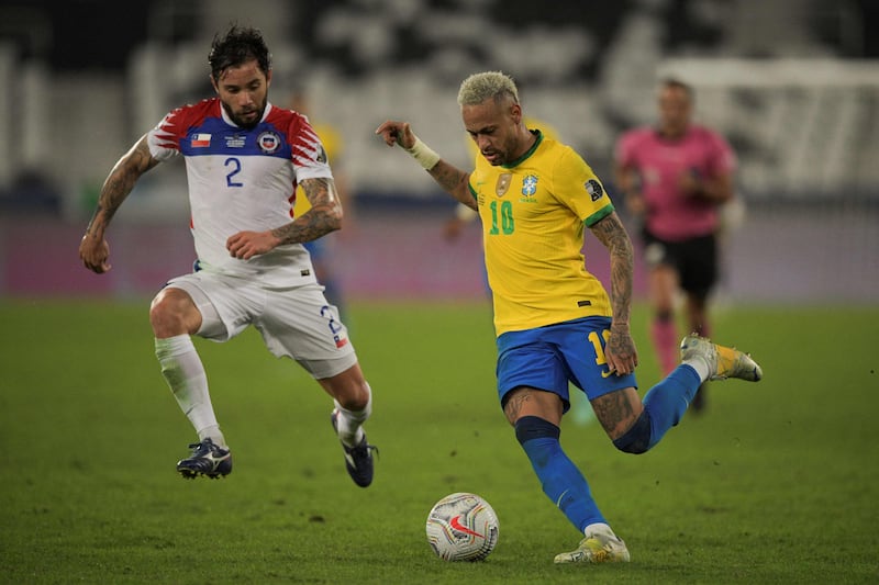 Chile's Eugenio Mena (L) and Brazil's Neymar in action.