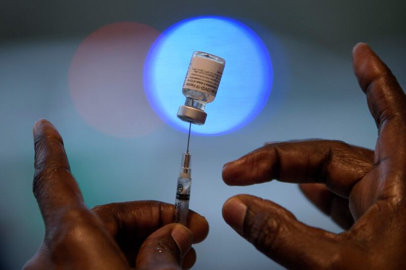 A healthcare worker prepares to administer a dose of the BioNTech Covid-19 vaccine at a vaccination hub in Texas. AFP