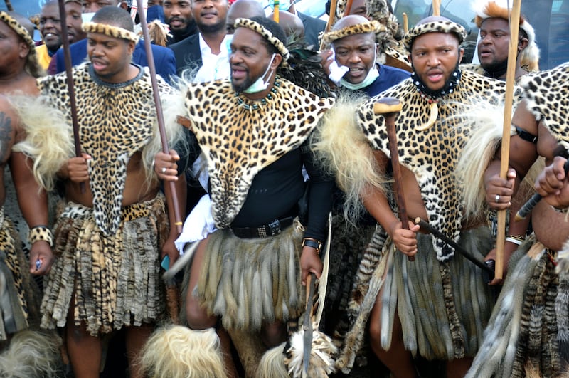 King Misuzulu Zulu, centre, with fellow warriors in traditional dress at the KwaKhangelamankengane Royal Palace in Nongoma, South Africa. AP