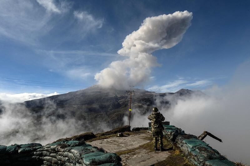 A Colombian soldier watches a volcano emit a cloud of ash at Nevado del Ruiz, Caldas department. AFP