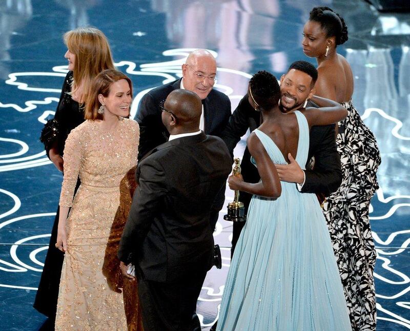 From left to right: Producer Bianca Stigter, actress Sarah Paulson, director Steve McQueen, producer Arnon Milchan, actresses Lupita Nyong'o and Adepero Oduye accept the Best Picture award for 12 Years a Slave from actor Will Smith (second from right) onstage during the Oscars at the Dolby Theatre on March 2, 2014 in Hollywood, California.   Kevin Winter / Getty Images / AFP