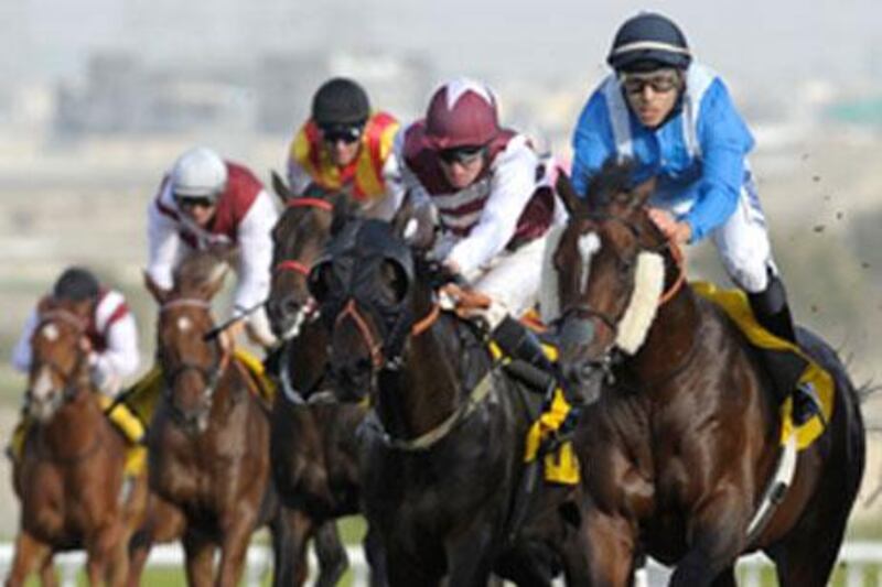 Apprentice jockey Abdullah Al Mansoori, right, rode Aqmaar to a debut win at Jebel Ali Racecourse, holding off veteran James Doyle.