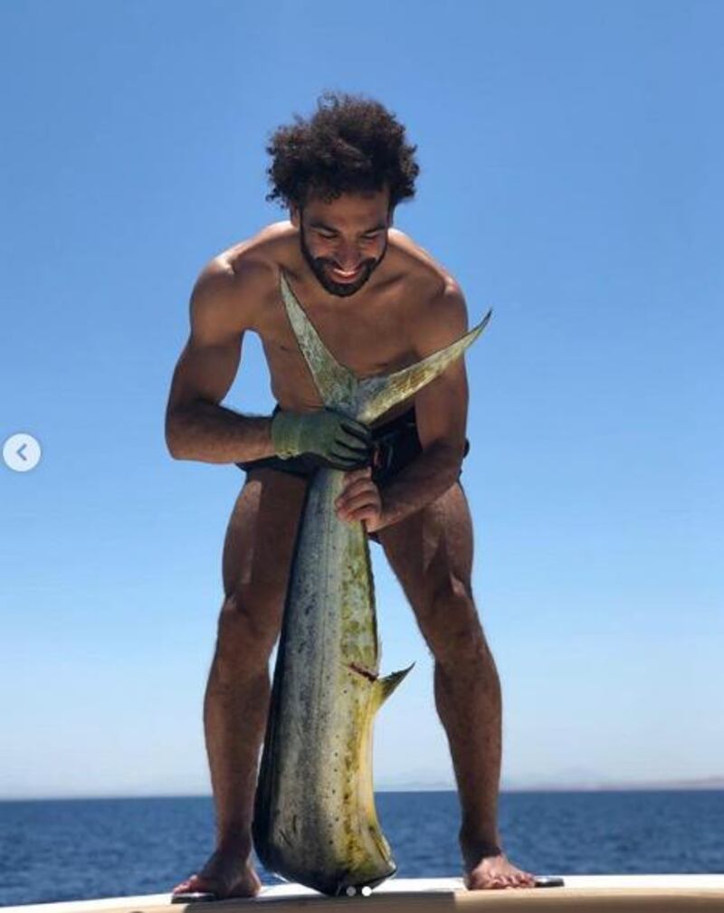 Mohamed Salah gets to grip with a fish on June 10, but it wasn't clear where he was located during a holiday on a luxury boat. Courtesy Mo Salah / Instagra
