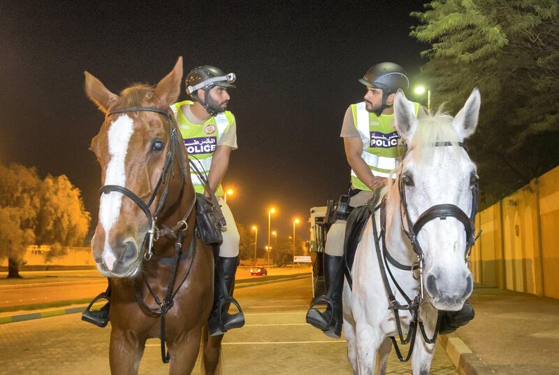 Abu Dhabi, United Arab Emirates- Police officers preparing to do patrol in a horse in Al Mushrif.  Leslie Pableo for The National for Haneen Dajani's story