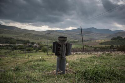 In this image released by World Press Photo, Thursday April 15, 2021, by Valery Melnikov, Sputnik, part of a series titled Paradise Lost, which won the first prize in the General News Stories category, shows A rocket remaining after the shelling of the city of Martuni (Khojavend), Nagorno-Karabakh, lies in a field, on 10 November, the day the peace agreement between Armenia and Azerbaijan came into effect. (Valery Melnikov, Sputnik, World Press Photo via AP)