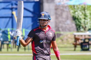 UAE batter Aryan Lakra raises his bat after reaching an ODI fifty on debut. Peter Della Penna / Cricket Scotland