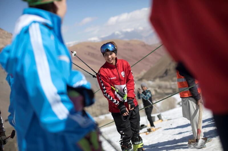 AFGHANISTAN, Bamiyan: 04 March 2021
Pictures from the annual Afghan Mountain Challenge - a ski event held in Bamiyan Province, 80 miles west of Kabul. Participants have to run up the mountain via specific checkpoints and then proceed to ski down. 
Pictured - A young female competitors prepares to take the rope tow up to the top of the mountain for her run. Rick Findler for The National