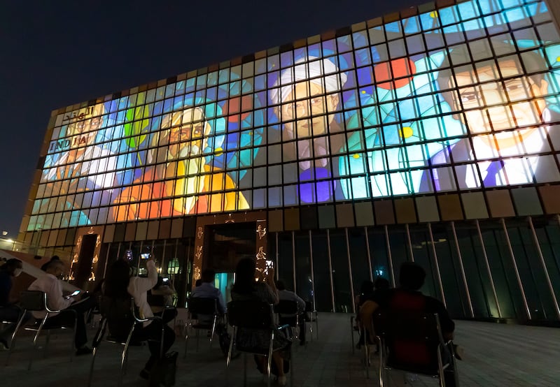 The facade of India's pavilion lights up at night to show different kinetic images.