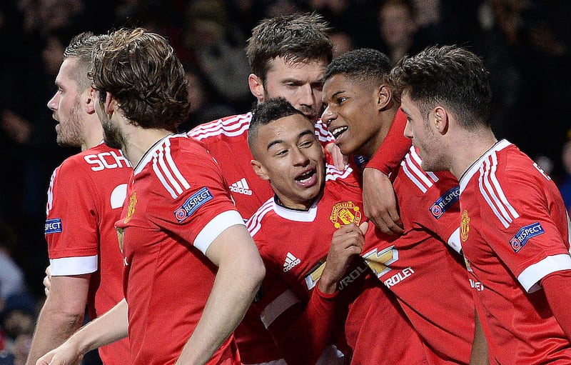 Manchester United's English striker Marcus Rashford (2R) celebrates scoring his team's third goal during the UEFA Europa League round of 32, second leg football match between Manchester United and and FC Midtjylland at Old Trafford in Manchester, north west England, on February 25, 2016. (Photo by OLI SCARFF / AFP)