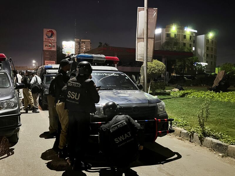 Officers take up positions outside the police headquarters attacked by gunmen in Karachi. Reuters