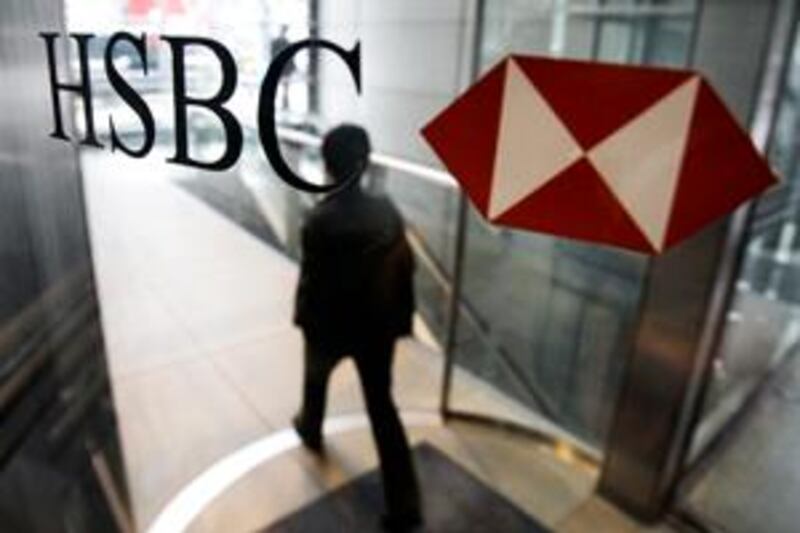 A man walks past a logo of HSBC Holdings PLC at the bank's headquarter in Hong Kong Monday, March 2, 2009.  HSBC PLC plans to scale back its consumer lending operations in the United States and to close hundreds of branches there, British and U.S. newspapers reported Sunday. The Financial Times and the Wall Street Journal said HSBC will announce the plans on Monday as it discloses its 2008 results and confirms a plan to raise 12 billion pounds ($17 billion) in a new rights issue.(AP Photo/Vincent Yu) *** Local Caption ***  XVY102_Hong_Kong_HSBC.jpg