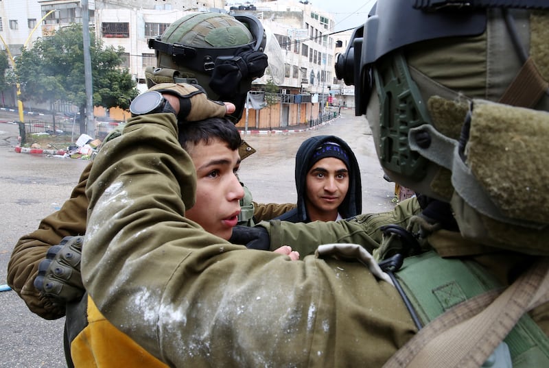 Israeli security forces detain a Palestinian boy. EPA