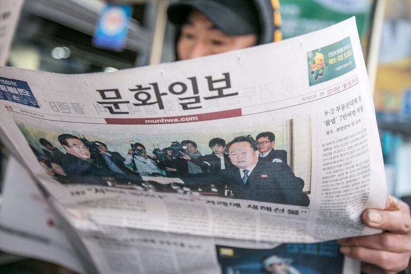 A man reads a newspaper featuring a photograph of Cho Myoung-gyon, South Korea's unification minister (L), shaking hands with Ri Son Gwon, chairman of North Korea’s Committee for the Peaceful Reunification of the Fatherland, on its front page in Seoul, South Korea, on Tuesday. Jean Chung / Bloomberg