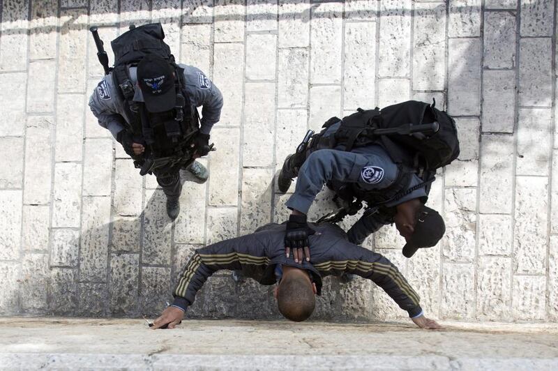 Israeli border police frisk a suspected Palestinians youth next to the Damascus Gate of the Old City of Jerusalem. Atef Safadi / EPA