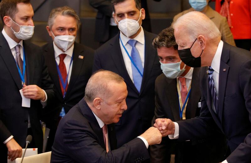 U.S. President Joe Biden, right, is greeted by Turkey's President Recep Tayyip Erdogan, center, during a plenary session at a NATO summit in Brussels, Monday, June 14, 2021. (AP Photo/Olivier Matthys, Pool)