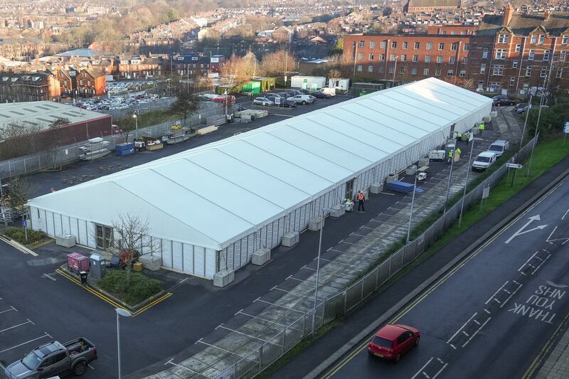 Workers erect a Nightingale Covid-19 surge hub in a car park at St James's University Hospital in Leeds. Getty Images