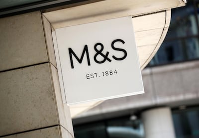 (FILES) In this file photo taken on July 20, 2020 A logo is pictured on a sign outside an M&S (Marks and Spencer) store in central London. British supermarket chain Marks & Spencer pledged on January 6, 2021, not to use cotton from China's Xinjiang region in clothing it sells, a move to call for "change" in Beijing's treatment of the Uyghur minority. / AFP / Tolga AKMEN
