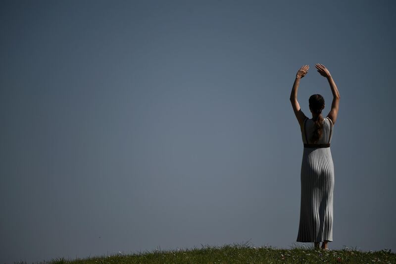A woman dressed as a priestess takes part in the Olympic flame lighting ceremony in ancient Olympia, Greece. AFP