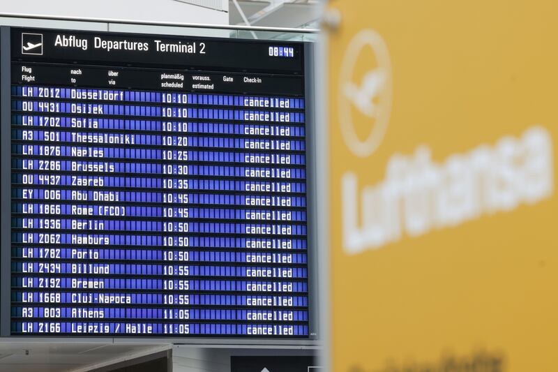 Flight information boards display cancelled flights at Munich International Airport. Bloomberg