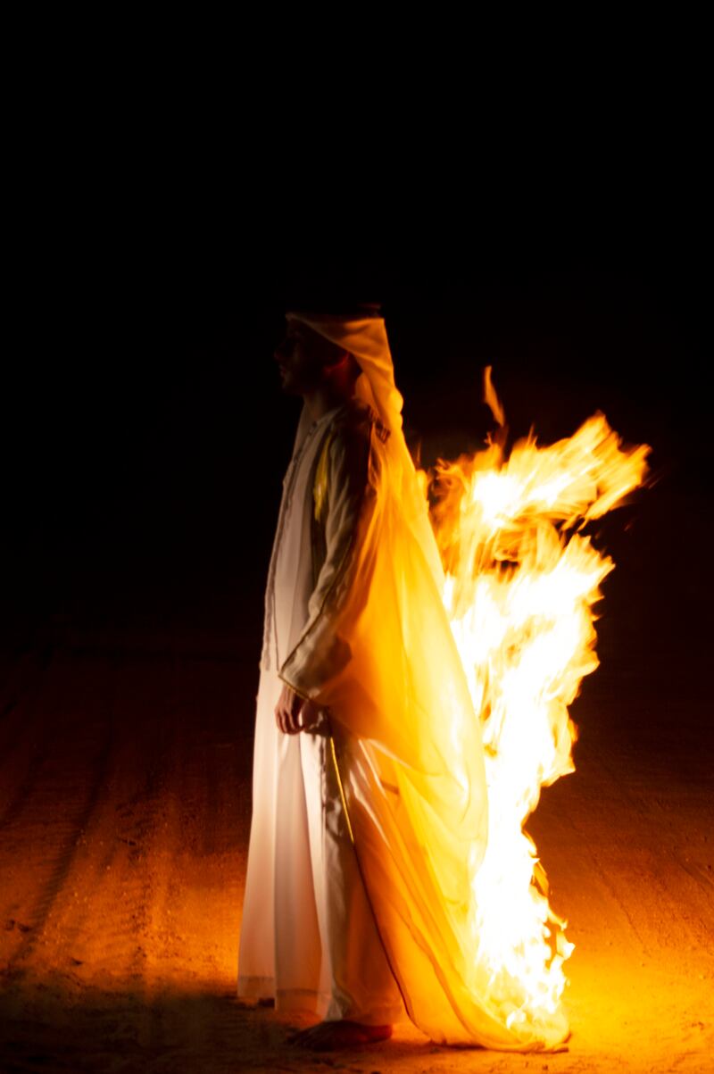 Mariam AlKatheeri's work shows a male subject walking in a dark desert with his traditional kandura ablaze. Photo: Mariam AlKatheeri