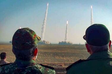 The head of Iran's Revolutionary Guard Corps Hossein Salami, right, watches the launch of missiles during a military drill in an unknown location in central Iran. Sepah News / AFP