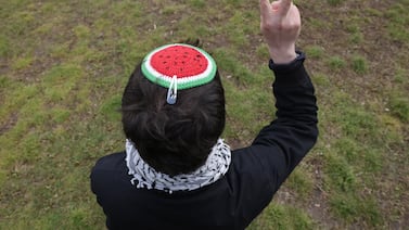 A protester wearing a watermelon yarmulke, in solidarity with Palestine, makes a peace sign as police clear a pro-Palestine protest camp near the Chancellery, on April 26, in Berlin, Germany. Getty Images