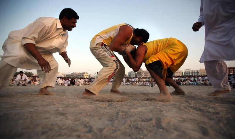 2009 file photo: Choudrey Jabar,left, and Pervaz Palvan Bahti compete during Kushti wrestling match in Dubai March 20, 2009. On some Friday afternoons near the Dubai Fish Market Thousands of people gather to watch traditional wrestling popular in India and Pakistan. (Sammy Dallal/The National) 
