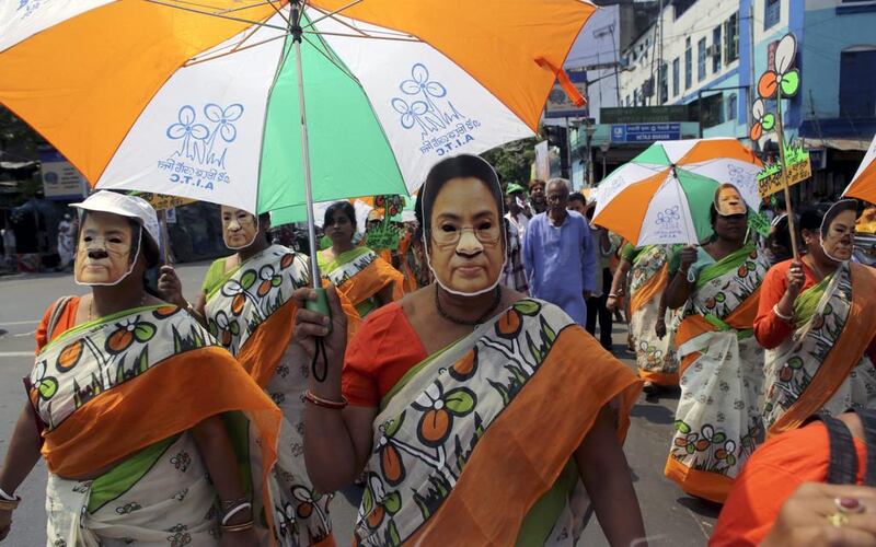 India Trinamool Congress party activists wear masks of Chief Minister of West Bengal Mamata Banerjee during an campaign for their candidate Subrata Bakshi in Calcutta. Piyal Adhikary / EPA   