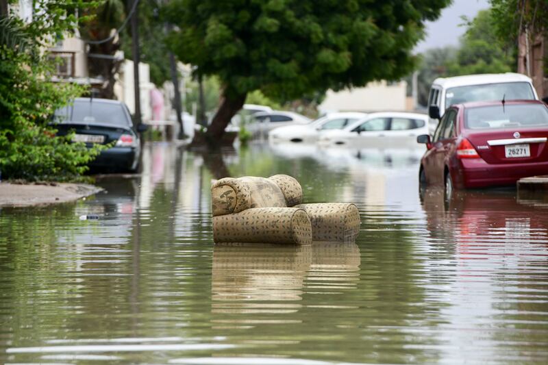 A floating sofa amid flooding in Kalba, Fujairah. Khushnum Bhandari / The National
