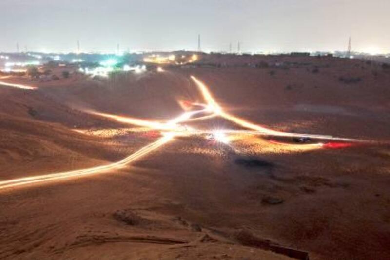 Ras al Khaimah, December 26, 2011 - A twenty-five second exposure captures the light trails of those drivers climbing the dunes as part of the Awafi Festival in Ras al Khaimah City, Ras al Khaimah, December 26, 2011. The tournament ends on January 7, 2012. (Jeff Topping/The National)