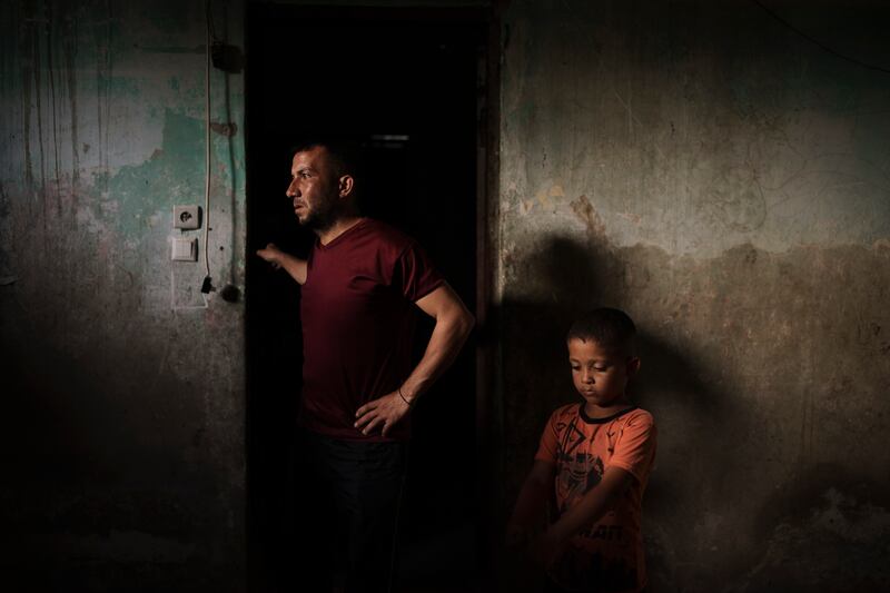 Jalal Nassir stands with his son in their home in Beit Hanoun. Four wars since 2008 have dealt damage worth billions to Gaza’s infrastructure. AP