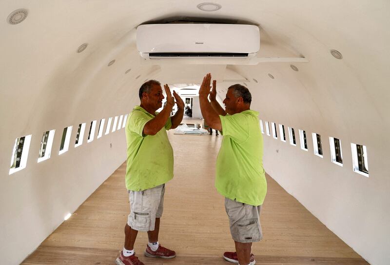 The brothers high-five each other inside the Boeing 707.