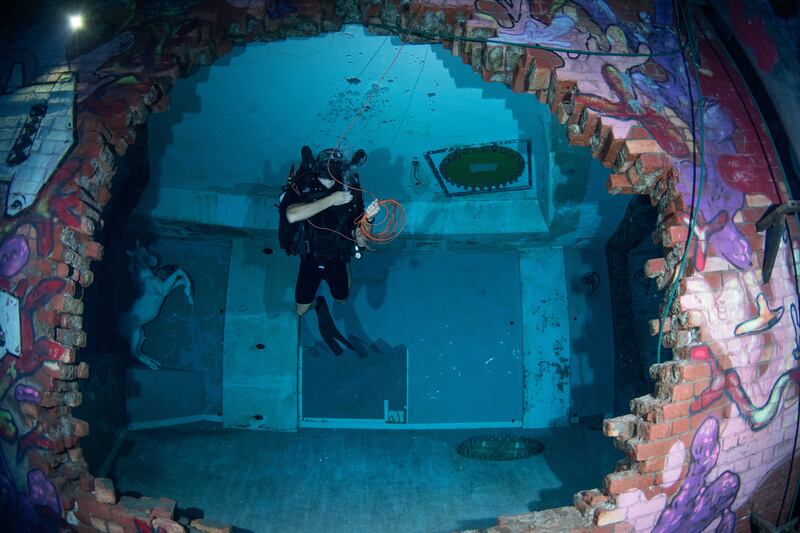 Royal Navy ship divers try out the new Deep Dive Dubai pool.