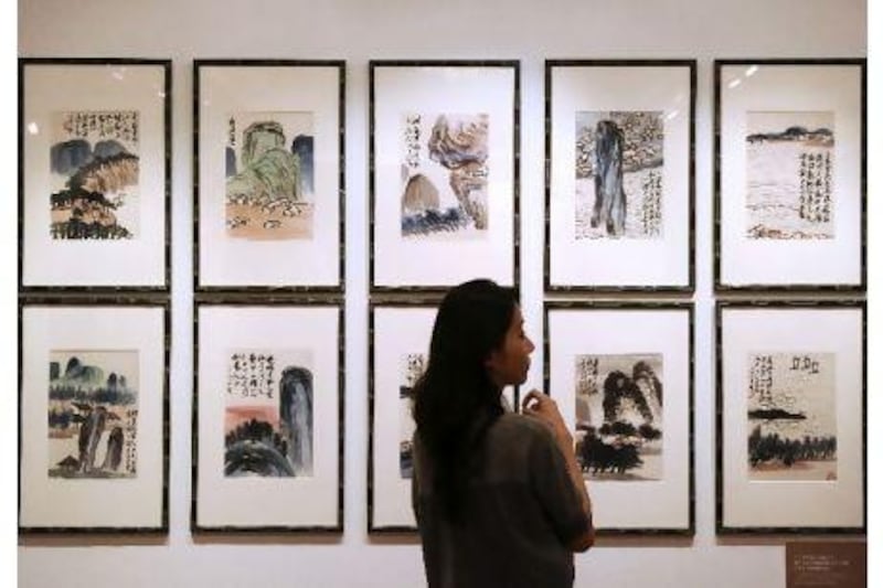The Chinese artist Qi Baishi's Landscapes is displayed at a China Guardian auction preview in Hong Kong last month, where total sales hit 1.75 billion yuan. Dale de la Rey / AFP