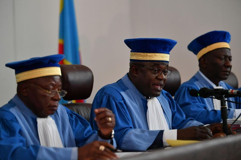 President of DR Congo's Constutional Court Noel Funga (C), leading a five-judge bench, makes a statement in Kinshasa on January 15, 2019, during the opening of the hearing of an electoral petition filed by opposition politician Martin Fayulu, who petitioned the court to nullify Felix Tshisekedi's victory in the December 30 presidential poll citing electoral fraud. DR Congo's Constitutional Court on January 15 began examining an appeal against presidential election results that gave victory to opposition leader Felix Tshisekedi, in a packed, heavily guarded courtroom. Official results released on January 10 by the Independent National Election Commission (CENI) gave Tshisekedi 38.57 of the December 30 vote, against Fayulu's 34.8 percent. / AFP / TONY KARUMBA
