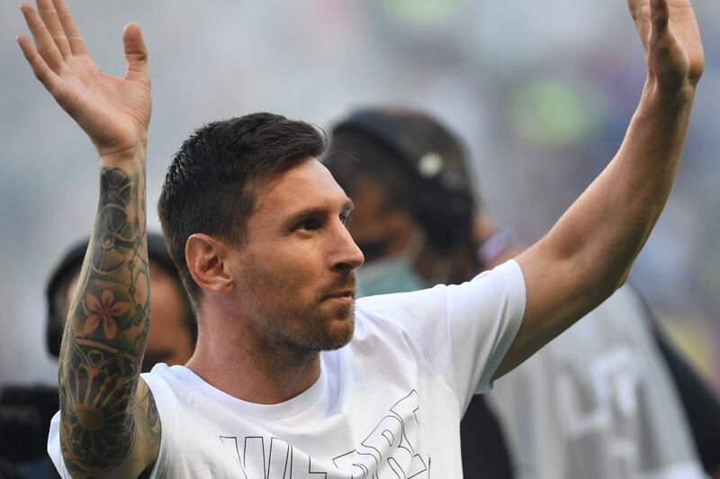 Paris Saint-Germain's Argentinian forward Lionel Messi waves hands to the supporters during a presentation ceremony prior to the French L1 football match between Paris Saint-Germain and Racing Club Strasbourg at the Parc des Princes stadium in Paris.