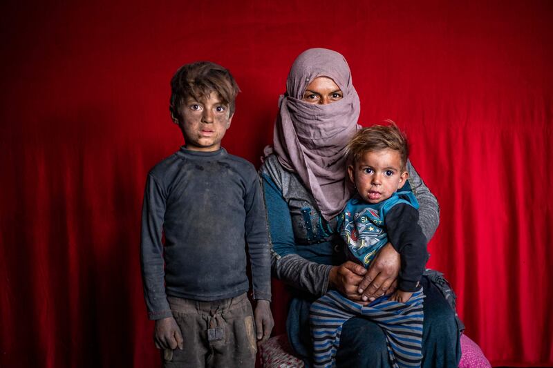 Displaced Syrians from Deir Ezzor pose for a picture at the Sahlah Al Banat camp. AFP