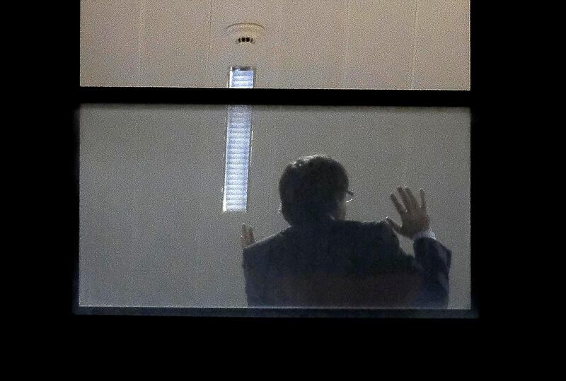 A man believed to be Carles Puigdemont gestures inside the public prosecutor's office in Brussels. Catalonia's sacked separatist leader Carles Puigdemont and four of his former ministers turned themselves in to Belgian police after Spain issued a warrant for their arrest.
Nicolas Maeterlinck  / AFP Photo / November 5, 2017