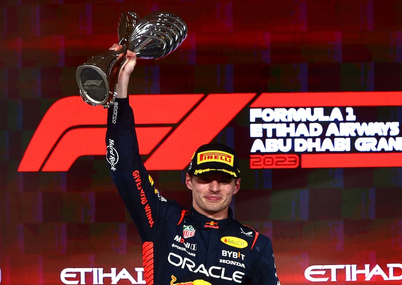 Race winner and world champion Max Verstappen of Red Bull  celebrates on the podium after his victory in the Abu Dhabi Grand Prix at Yas Marina Circuit on November 26, 2023. Getty Images