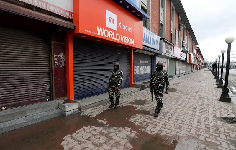 epa08328397 Indian paramilitary soldiers walk near a closed market  during a government-imposed nationwide lockdown as a preventive measure against the Covid-19 in Srinagar, the summer capital of Indian Kashmir, India, 28 March 2020. Seven more COVID-19 positive cases were reported in the Kashmir Valley on Saturday. This takes the total number of coronavirus COVID-19 cases in Kashmir to 21 and in the entire Jammu and Kashmir Union Territory to 27, according to local news reports.  EPA/FAROOQ KHAN