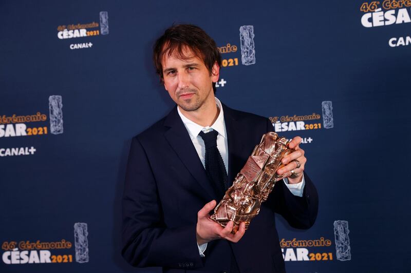 Director Stephane Demoustier poses during a photocall after receiving the Best Adapted Screenplay Award for his film "La fille au bracelet" (The Girl with a Bracelet) during the 46th Cesar Awards ceremony at the Olympia concert hall  in Paris, France, March 12, 2021. Thomas Samason/Pool via REUTERS