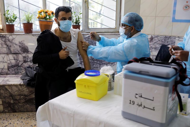 A man receives a vaccine against the coronavirus disease in Baghdad. Reuters