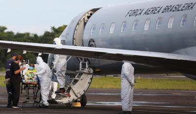 Health workers transport a COVID-19 patient to a Brazilian Air Force airplane before being moved to Maranhao state, amid the coronavirus disease (COVID-19) outbreak in Manaus, Brazil January 15, 2021. REUTERS/Bruno Kelly