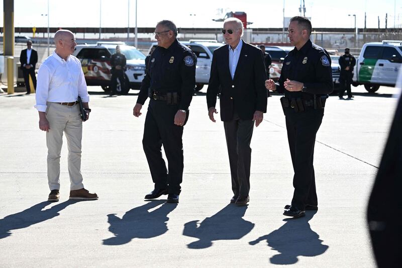 Mr Biden and Secretary of Homeland Security Alejandro Mayorkas (left) speak with US Customs and Border Protection police. AFP