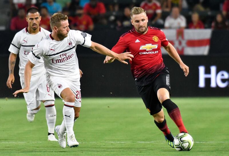 Manchester United's Luke Shaw moves the ball past AC Milan's Ignazio Abate. Reuters