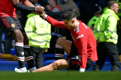 Manchester United's Paul Pogba helps teammate Cristiano Ronaldo get back on his feet at the end of the match. AP